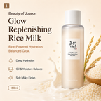 Beauty of Joseon Glow Replenishing Rice Milk in a frosted glass bottle with a white cap, surrounded by rice grains, a milk splash, and Korean text on a warm beige background.