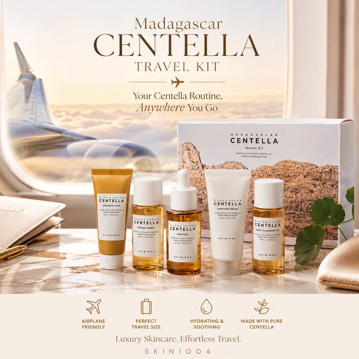 Madagascar Centella Travel Kit by SKIN1004 displayed on a marble surface with an airplane window view in the background. The set includes a white box, a gold tube, a white dropper bottle, a white tube, and a small amber bottle, with travel icons at the bottom.