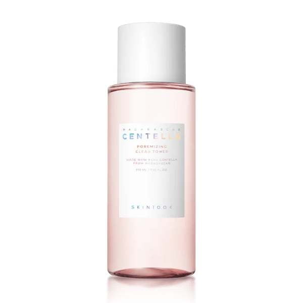 Skincare bottle with pink liquid and white cap on a white background